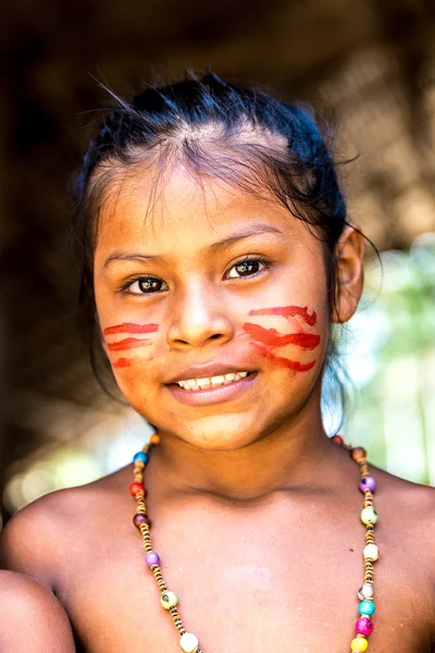 Native Brazilian girl smiling at an indigenous tribe in the Amazon