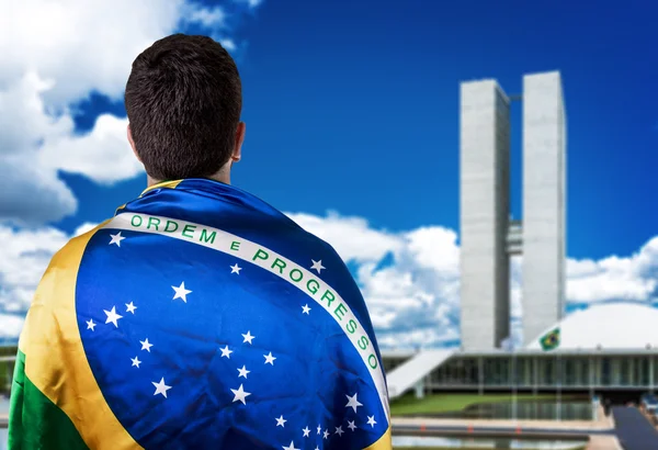 Man holding the Brazilian flag in Brasilia, Brazil