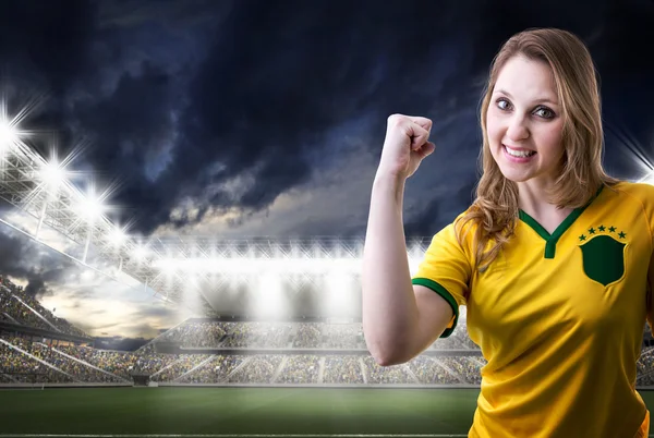 Brazilian female fan celebrating in the stadium