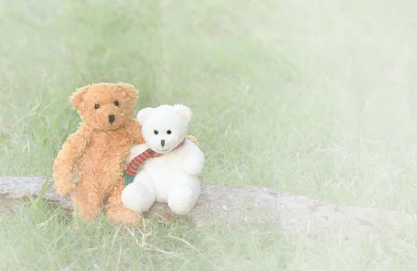 Two teddy bears hugging on paper textured background