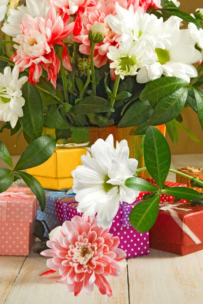 Images of flowers and gift boxes on a wooden table