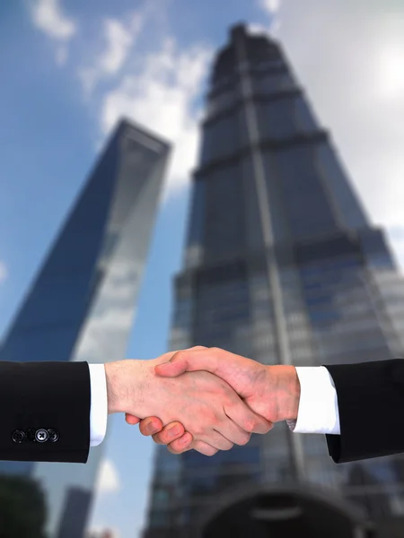 Businessman teamwork partners shaking hands with suit