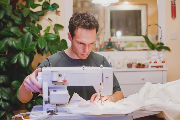 Man with sewing machin