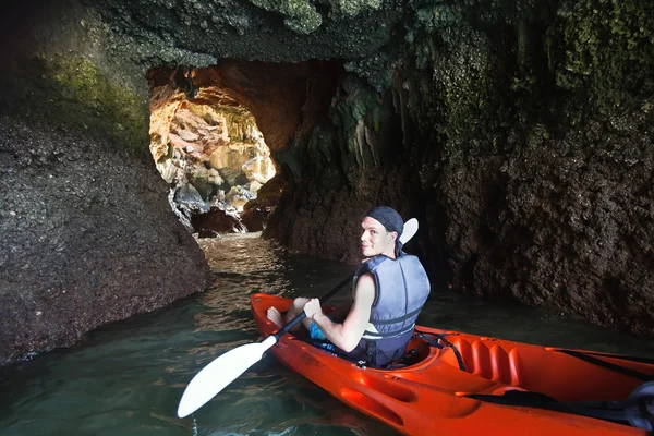 Man kayaking in cave