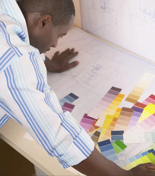 Male architect viewing color swatches