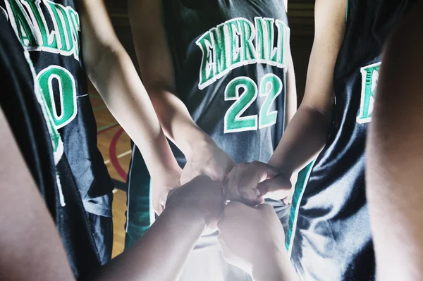 Girl\'s hands in team huddle