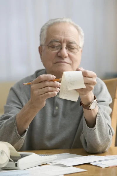 Stressed older man doing his taxes