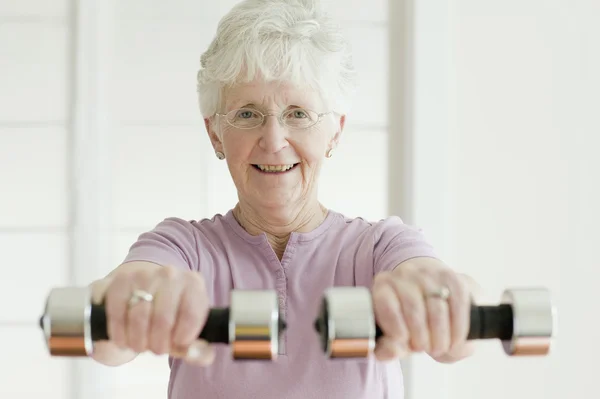 Senior woman lifting free weights