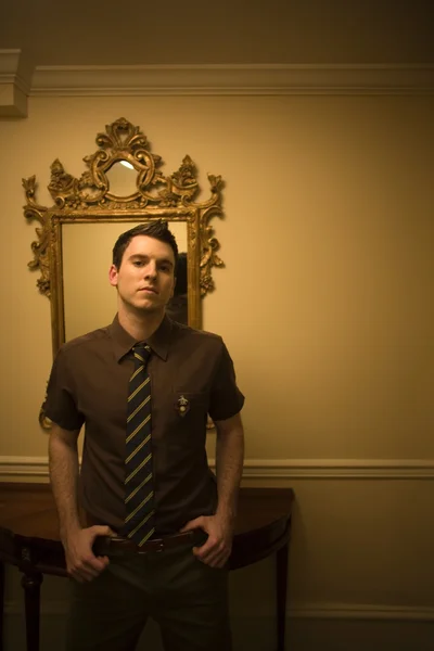Man wearing tie in front on mirror