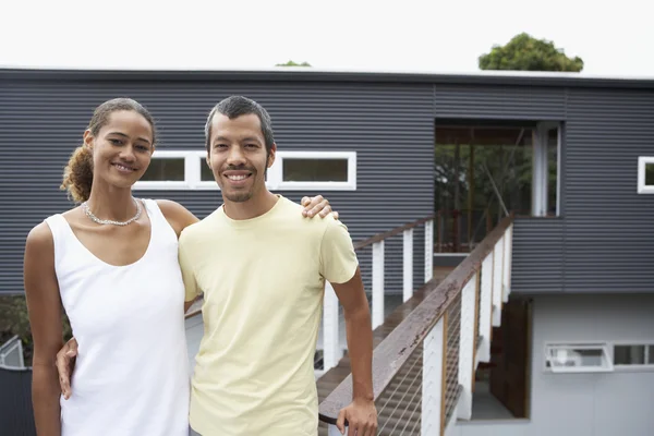 Multi-ethnic couple in front of house