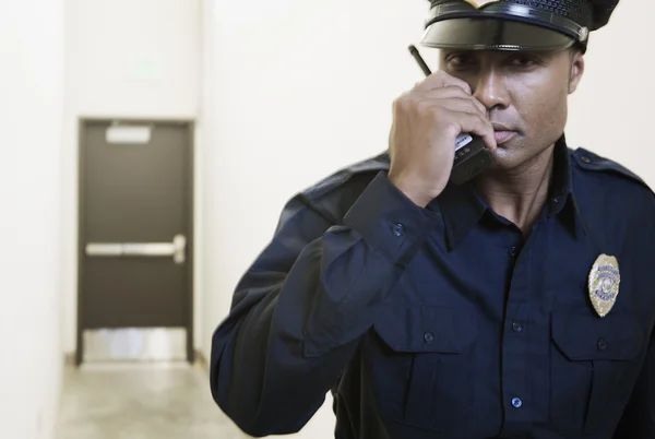 Security guard using a walkie-talkie