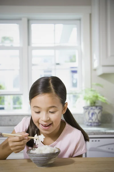 Asian girl eating rice