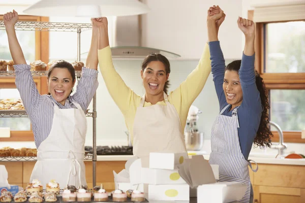 Three woman cheering in bakery