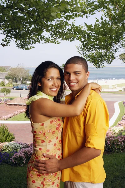 Hispanic couple hugging at beach resort