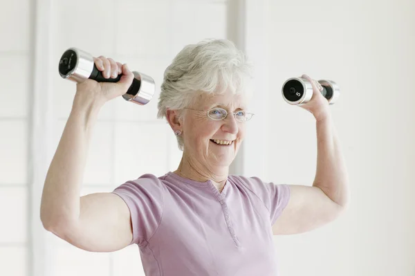 Senior woman lifting free weights