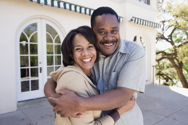 African American couple hugging outdoors