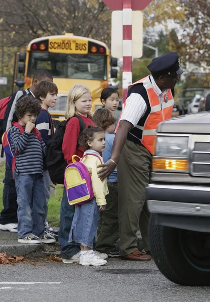 Children on street with crossing guard