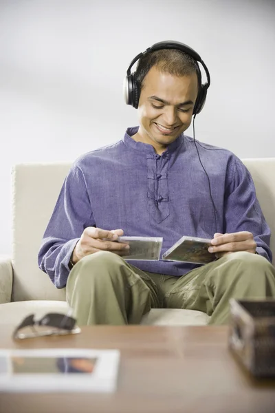 Indian man listening to music on headphones