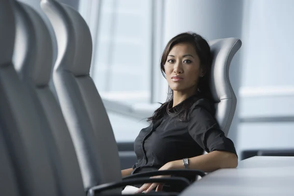 Asian businesswoman sitting in conference room