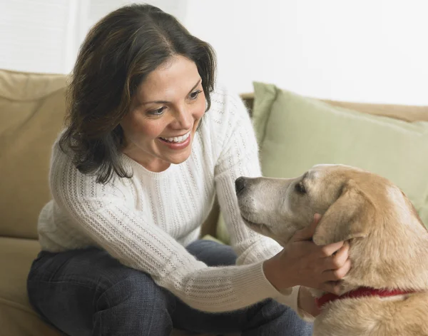 Young woman petting her dog