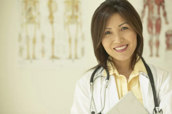 Asian female doctor holding chart