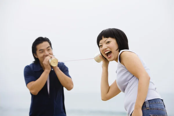 Asian couple playing with can