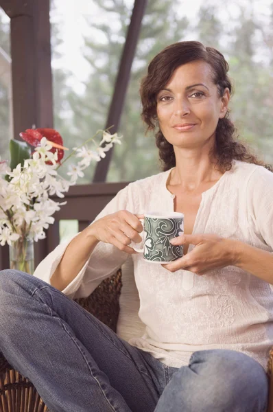 Mature woman holding coffee mug