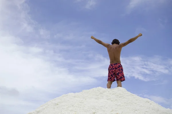 Hispanic man with arms raised