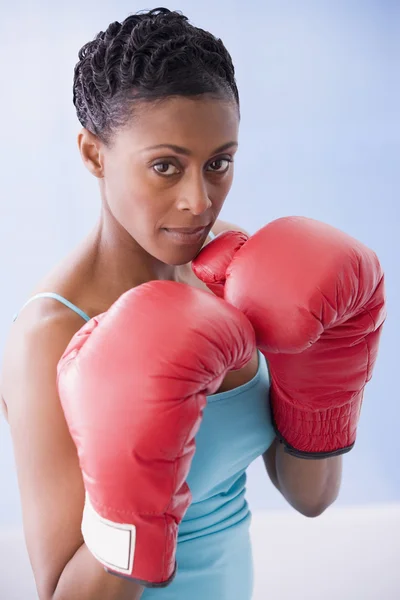 African American woman wearing boxing gloves