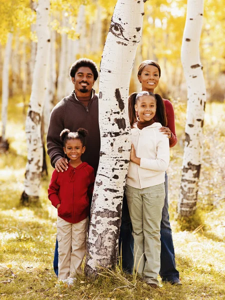 African family standing next to tree