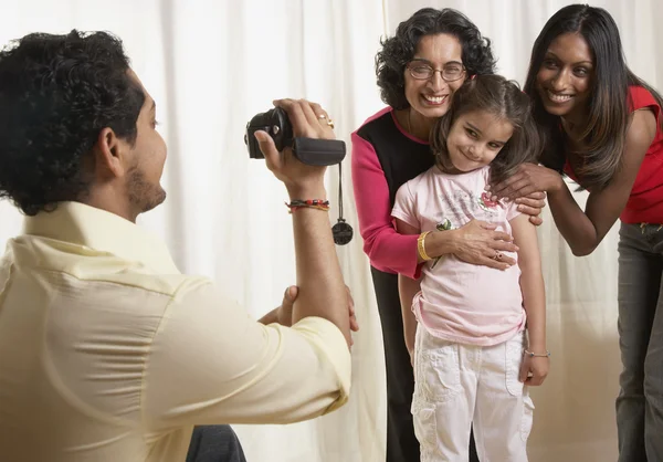 Indian father video recording family