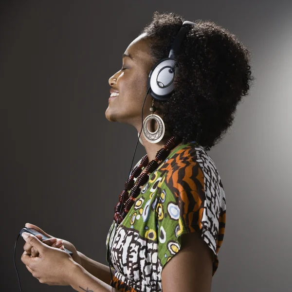 African American woman listening to headphones