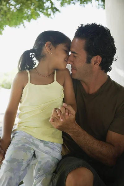 Hispanic father and daughter hugging