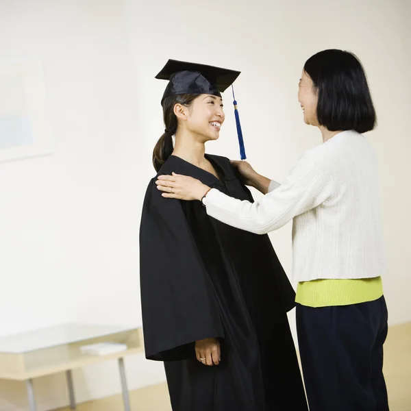 Asian graduate smiling at mother