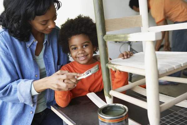 African mother and son painting rocking chair