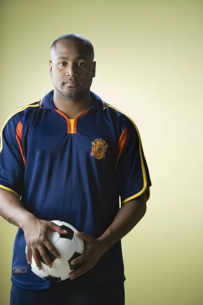 African American man holding soccer ball