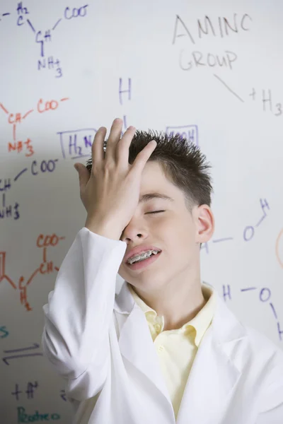 Hispanic boy in front of molecular formulae
