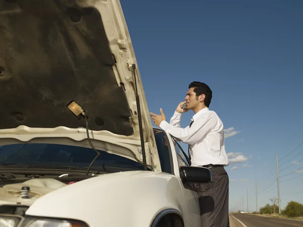 Hispanic man broken down on side of road