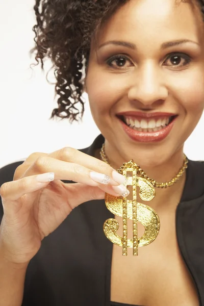 Mixed Race woman wearing dollar sign necklace