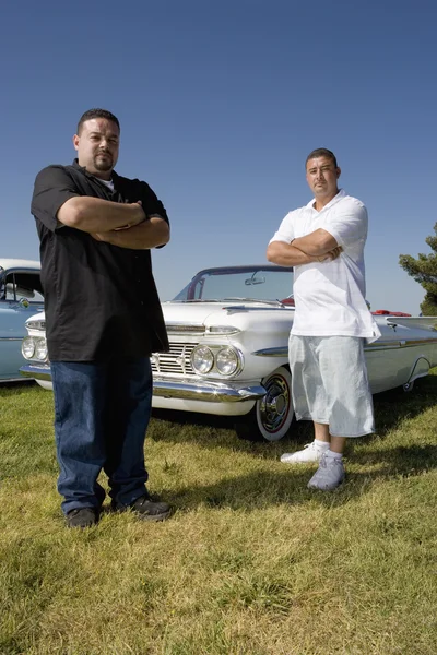 Hispanic men in front of low rider car