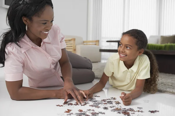 Mother and daughter playing with puzzle