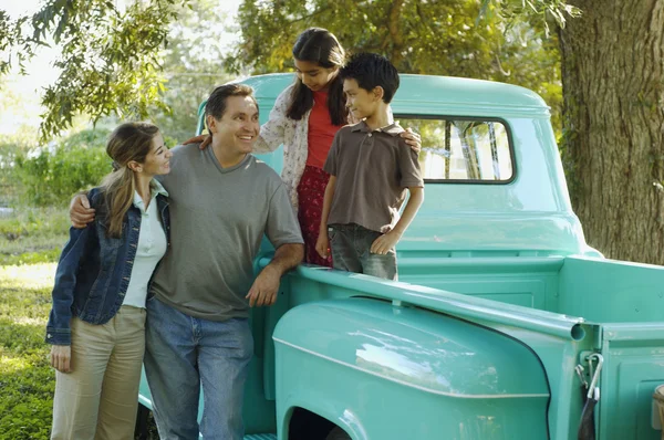 Multi-ethnic family in back of truck