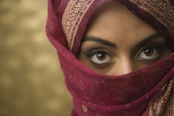 Middle Eastern woman wearing face covering