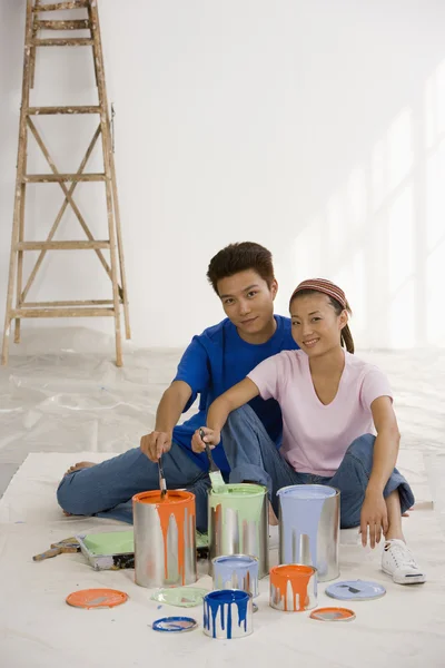 Asian couple with painting supplies