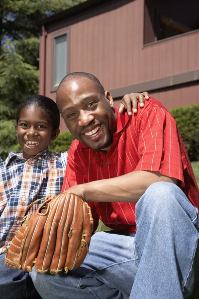 African father and son with baseball glove