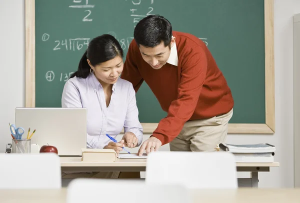 Asian teachers looking at paperwork | Stock Images Page | Everypixel