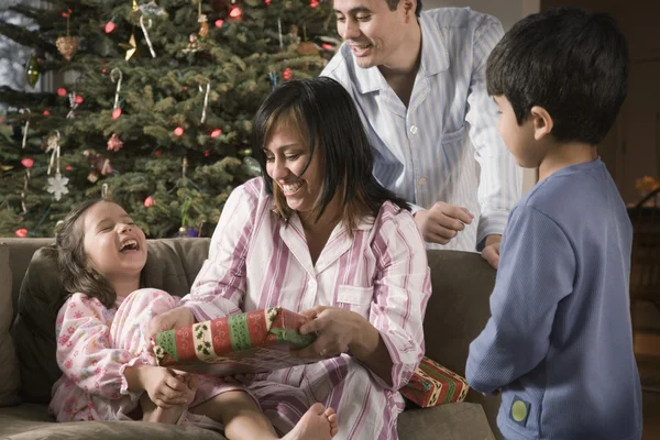 Hispanic family opening gifts on Christmas