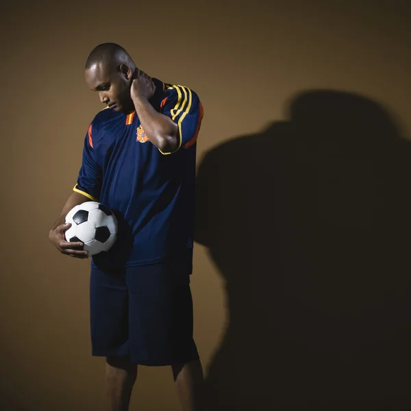 African American man holding soccer ball