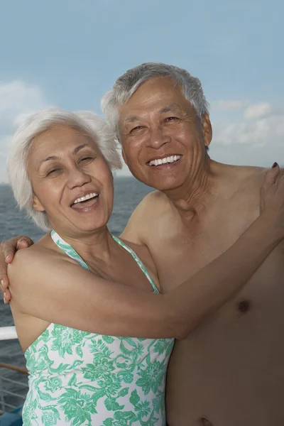 Senior Asian couple hugging