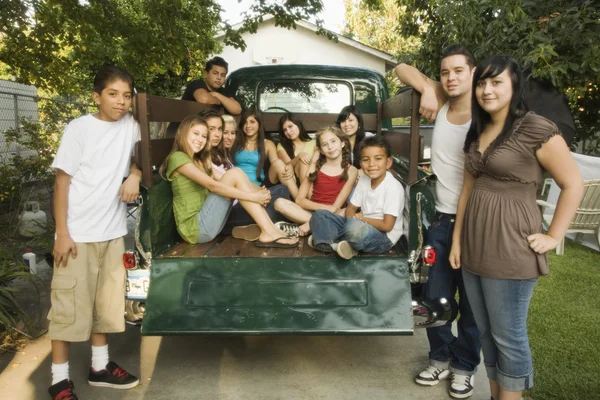 Teenagers and young adults in back of truck